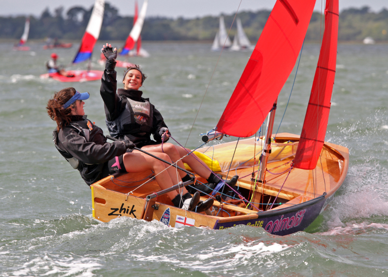 Beautiful wooden Mirror dinghy being sailed upwind by two girls 